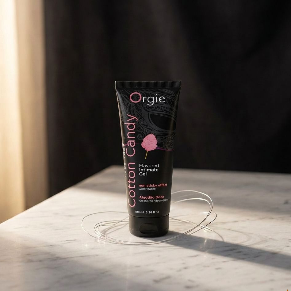 Tube of Orgie Cotton Candy flavored intimate gel on a marble surface with a dark background
