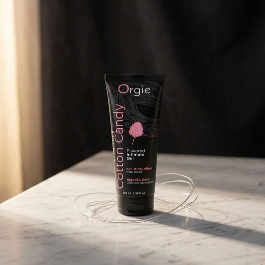 Tube of Orgie Cotton Candy flavored intimate gel on a marble surface with a dark background