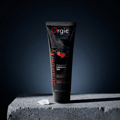 Tube of Orgie Strawberry flavored intimate gel on a dark background
