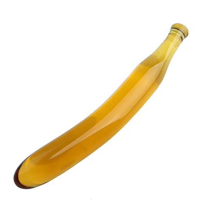 The Citrine glass sculpture by Sigh. A translucent yellow borosilicate glass dildo with a pronounced curve, resembling a stylized banana or crescent moon.