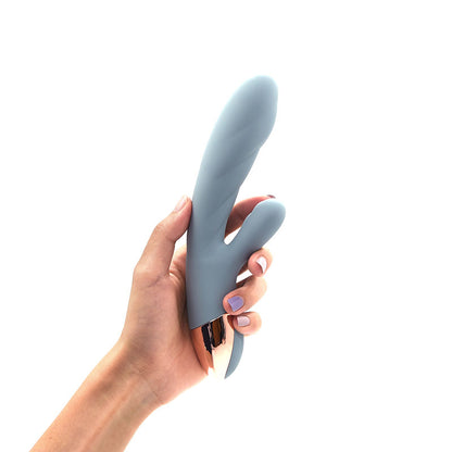 The Crescent luxury rabbit vibrator by Sigh. . . in Arona Blue. A dual-action silicone vibrator featuring a sleek, ergonomic design for G-spot and clitoral stimulation, shown in a soft blue-grey hue.