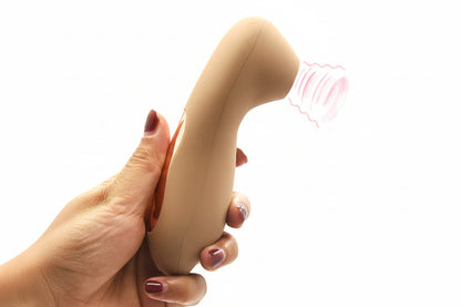 Hand holding the hUsh with a pink nozzle on a white background