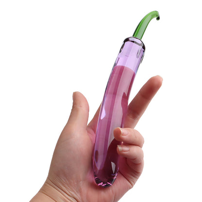 Hand holding a pink and green tool against a white background