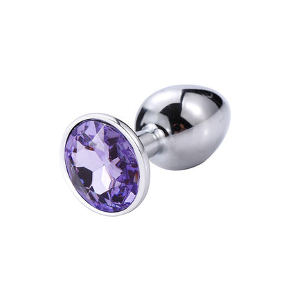 Jewel Anal Plug in Deep Green, showing the smooth tapered metal shaft and the sparkling gemstone base."